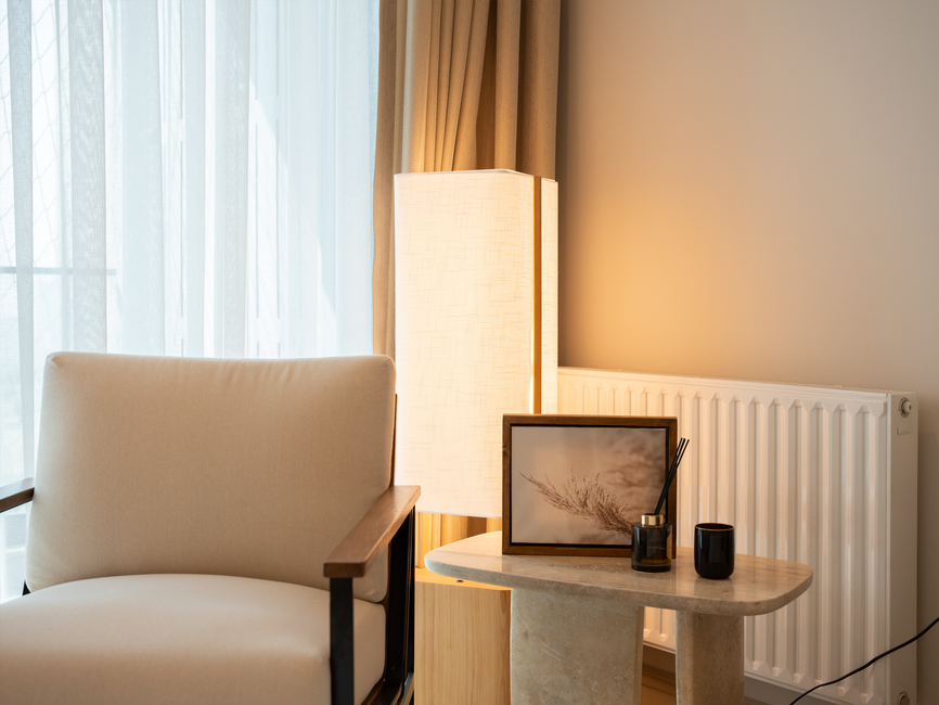 A calm, softly lit room with simple furniture and a soft rug