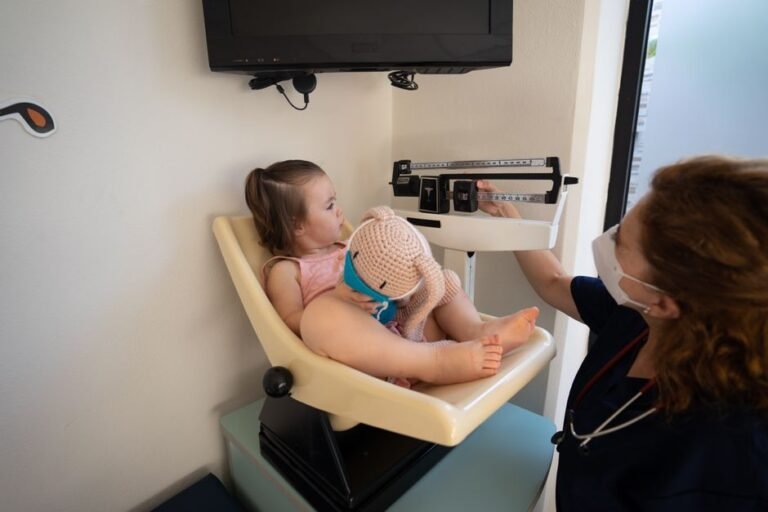 A child sitting calmly on a parent's lap in a pediatrician's waiting room