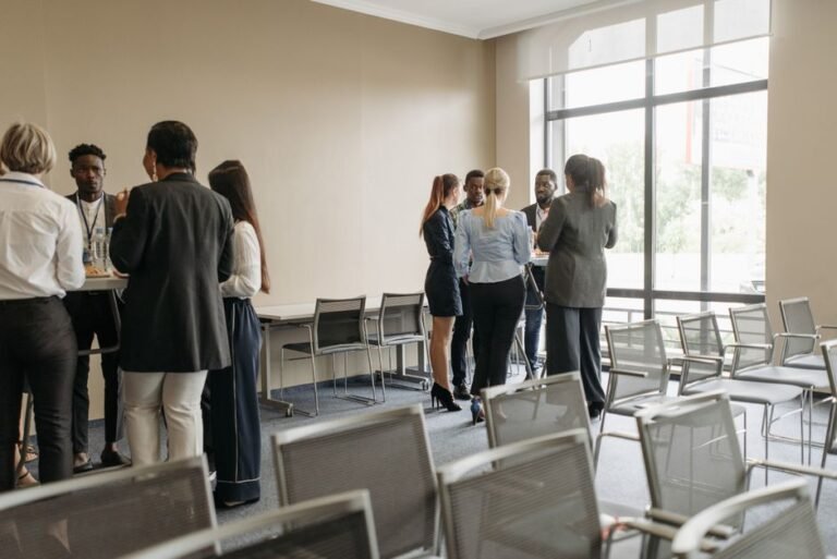 A diverse group of people talking together in a community space