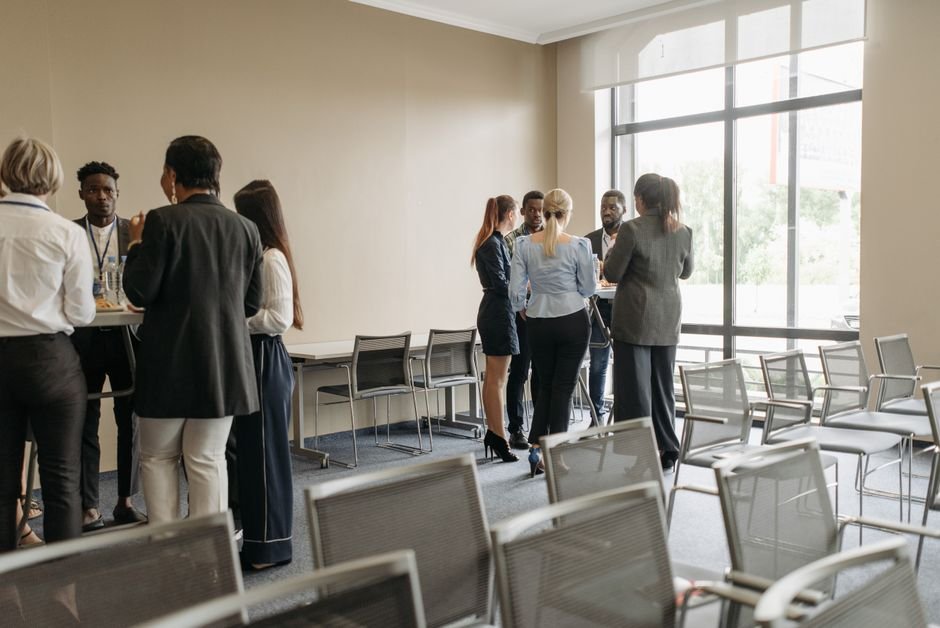 A diverse group of people talking together in a community space