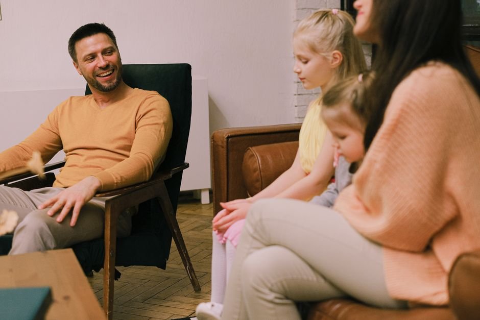 A parent and an older relative talking quietly at a table during a family gathering