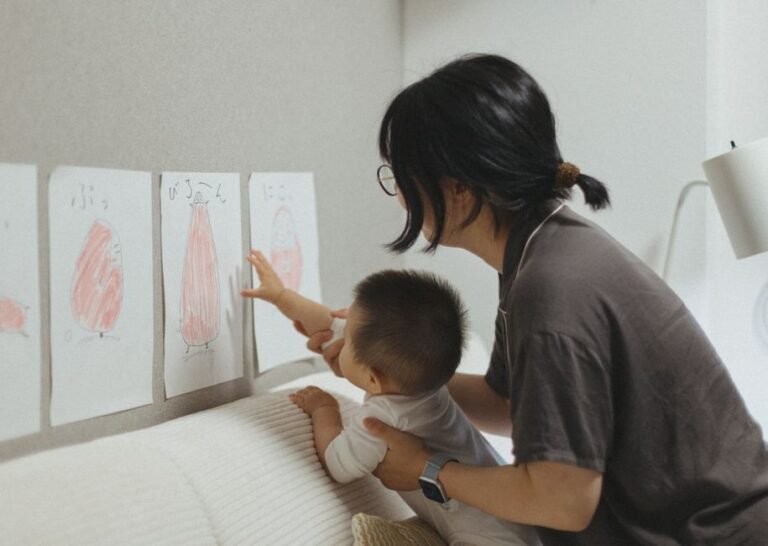 A parent reviewing a printed child development chart at a kitchen table