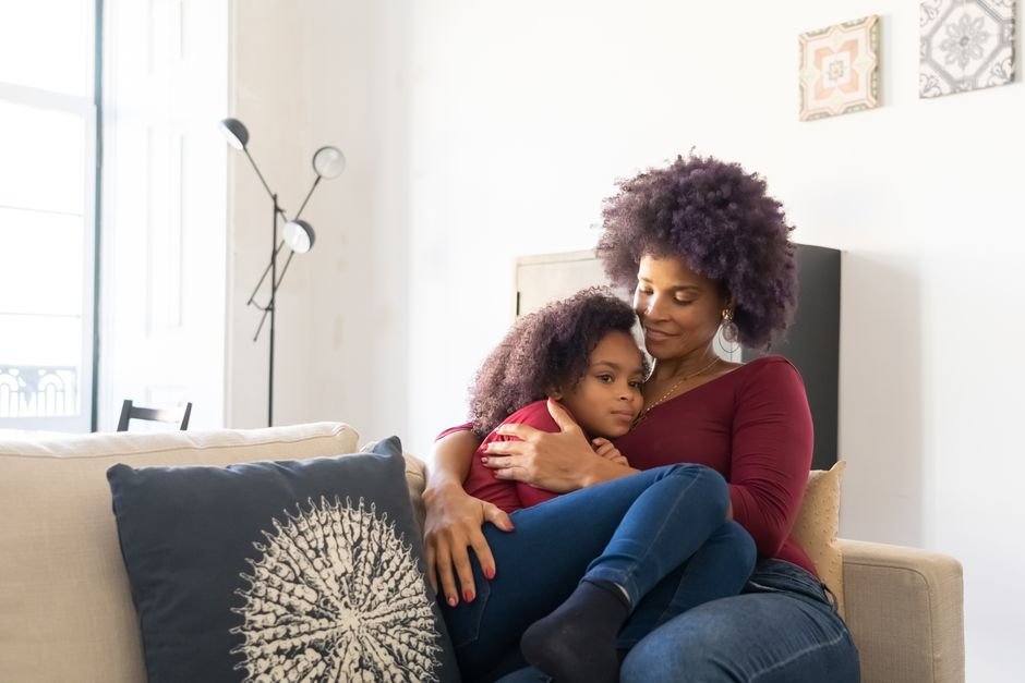 What Co-Regulation Actually Means for a Parent and Child A parent sitting quietly on the floor next to a child in a calm, softly lit room