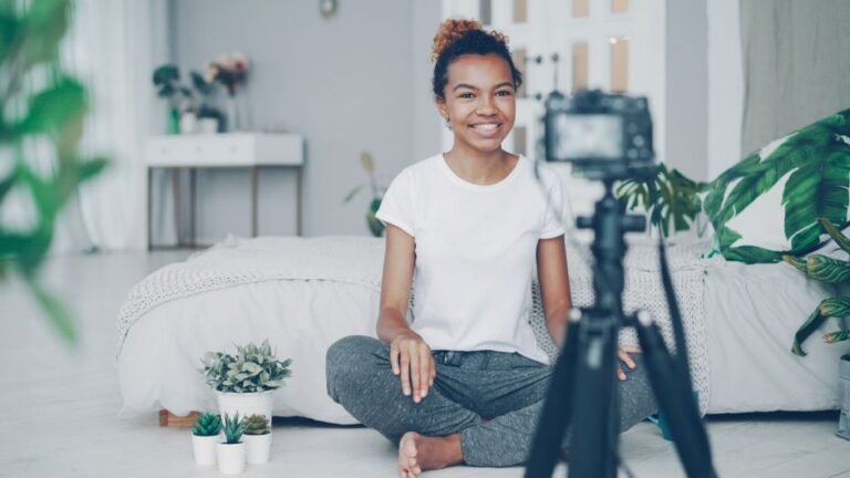 A person smiling while focused on a hobby at a table