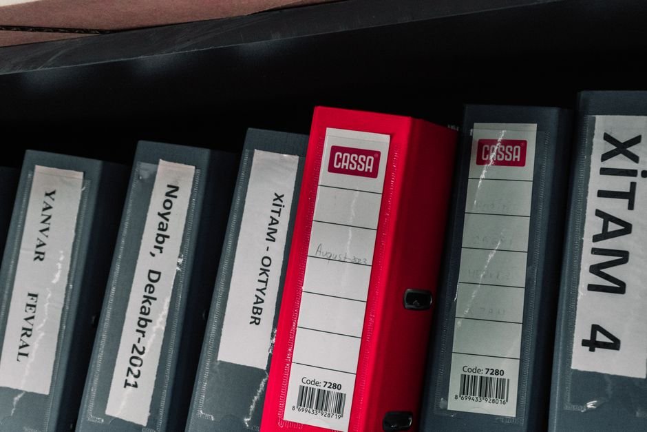 Two labeled folders of school paperwork sitting on a desk