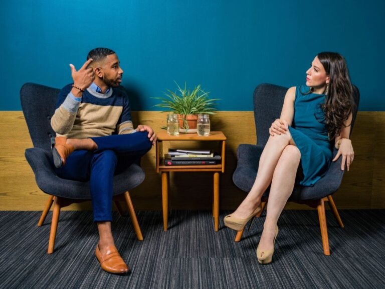 Two people mid-conversation, both looking puzzled