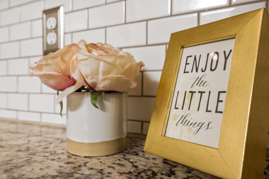 A visual schedule chart with picture cards hanging on a kitchen wall